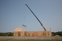 Crane placing roof joists